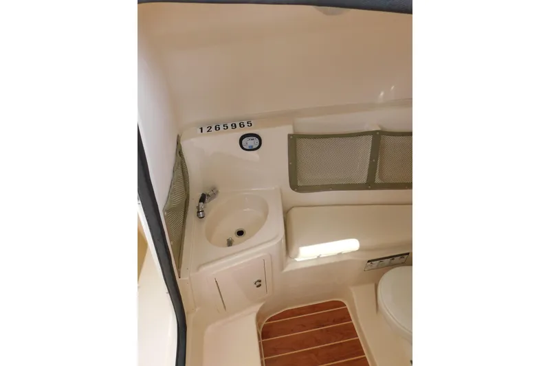Slide: The Image of Interior of 2015 Grady-White Freedom 307 boat, featuring sink and storage area. - 32