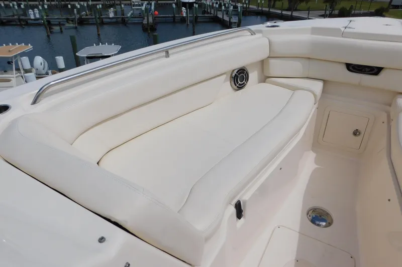 Slide: The Image of 2015 Grady-White Freedom 307 boat interior with white cushioned seating and speaker. - 37