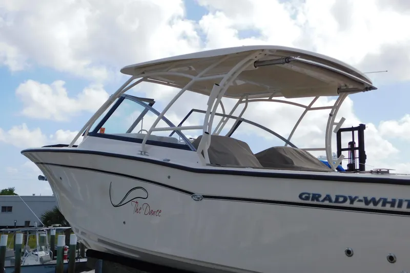 Slide: The Image of 2015 Grady-White Freedom 307 boat docked under a cloudy sky. - 4