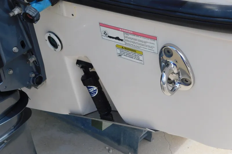 Slide: The Image of 2015 Grady-White Freedom 307 boat stern with warning labels and hardware details. - 44