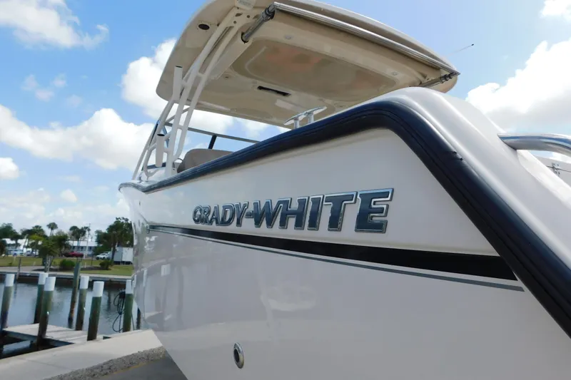 Slide: The Image of 2015 Grady-White Freedom 307 boat docked under a clear blue sky. - 5