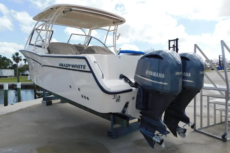 Slide: The Image of 2015 Grady-White Freedom 307 boat with twin Yamaha 300 engines on a dock. - 6