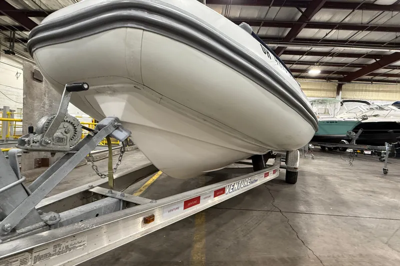 Slide: The Image of 2013 Mercury 560 boat on trailer in indoor storage facility. - 1