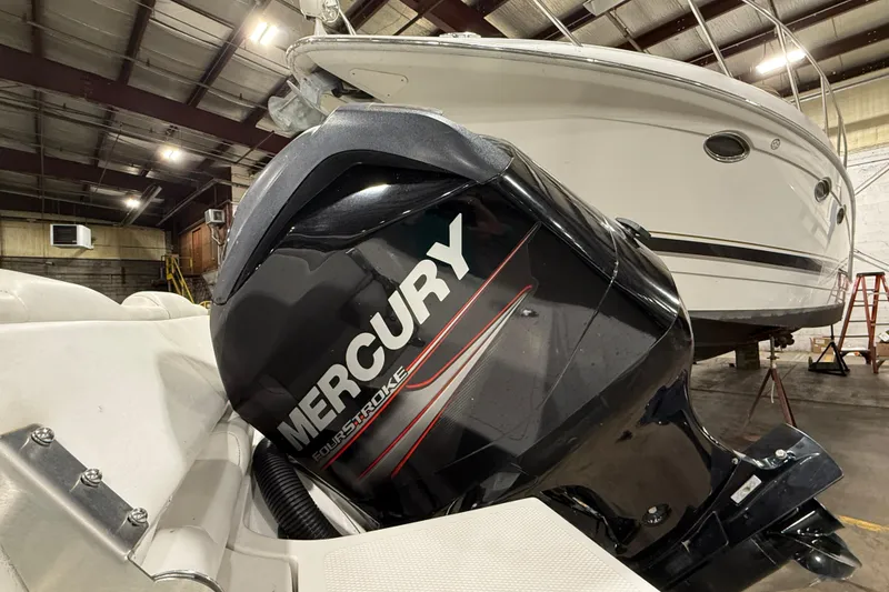 Slide: The Image of 2013 Mercury 560 outboard motor in a boat storage facility. - 3