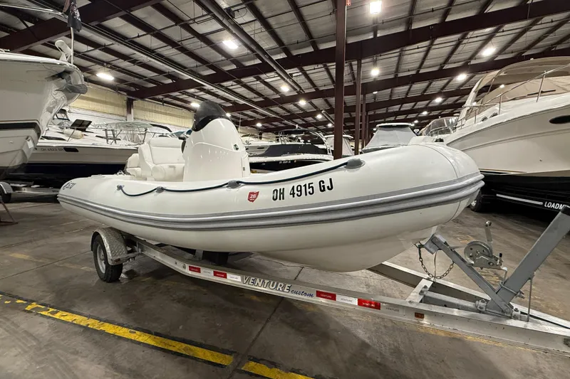 Slide: The Image of 2013 Mercury 560 inflatable boat on trailer in indoor storage facility. - 7