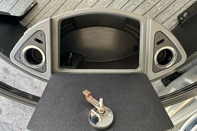 Slide: The Image of 2026 Ranger Reata 223FC boat interior with cup holders and storage compartment. - 10