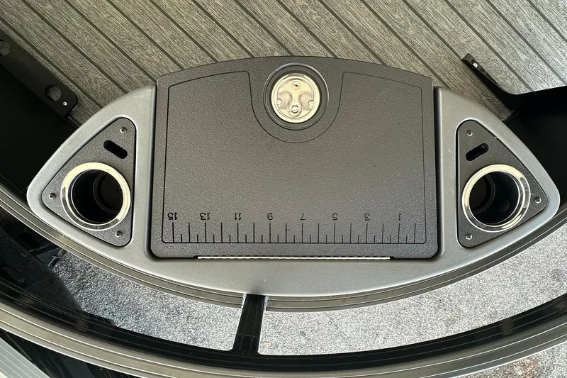 Slide: The Image of 2026 Ranger Reata 223FC boat deck with cup holders and measuring board. - 11