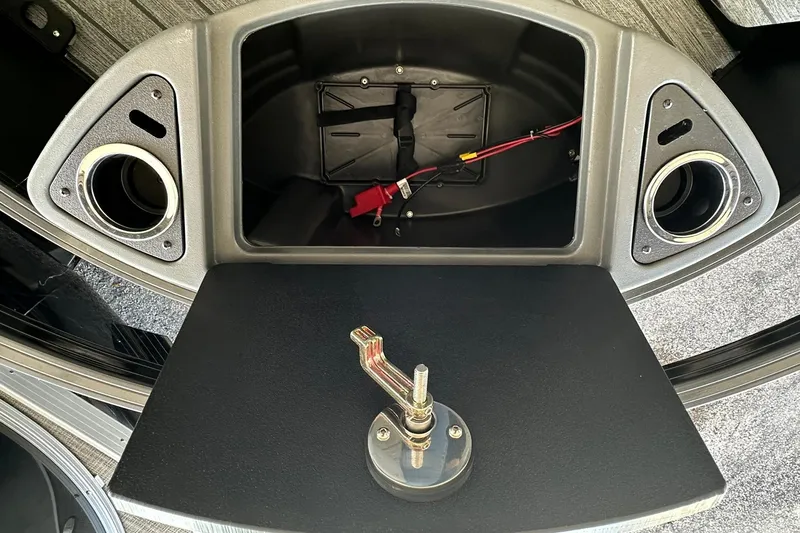 Slide: The Image of 2026 Ranger Reata 223FC boat compartment with wiring and cup holders. - 12