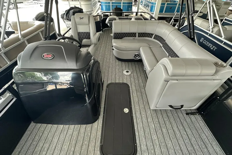 Slide: The Image of 2026 Ranger Reata 223FC boat interior with sleek seating and modern helm design. - 14
