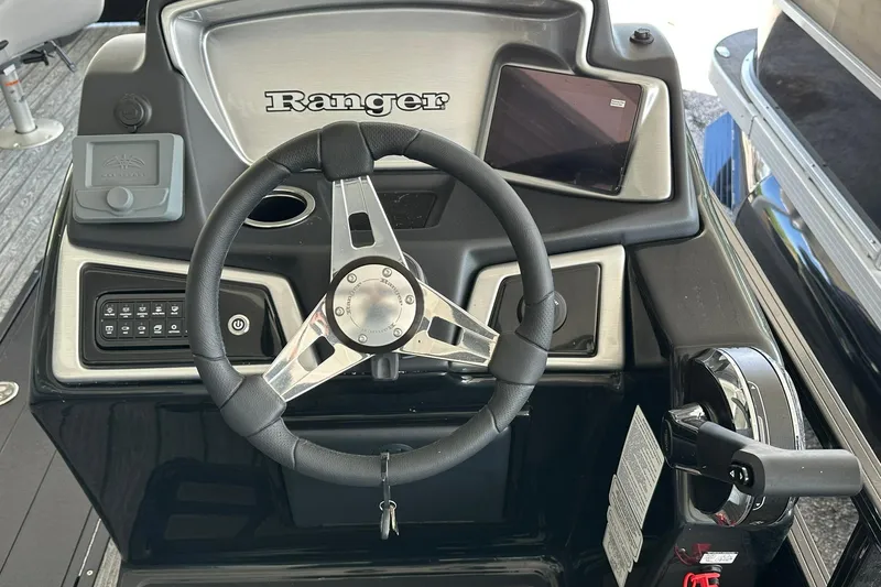Slide: The Image of 2026 Ranger Reata 223FC boat dashboard with steering wheel and controls. - 18