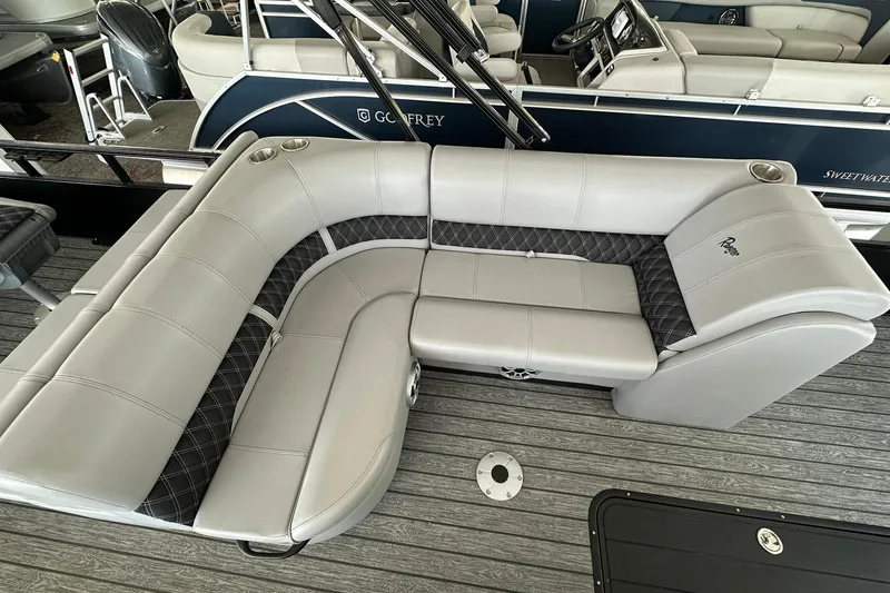 Slide: The Image of 2026 Ranger Reata 223FC boat interior with gray seating and cup holders. - 25