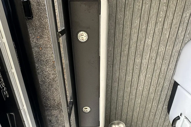 Slide: The Image of 2026 Ranger Reata 223FC boat interior with textured flooring and storage compartment. - 28