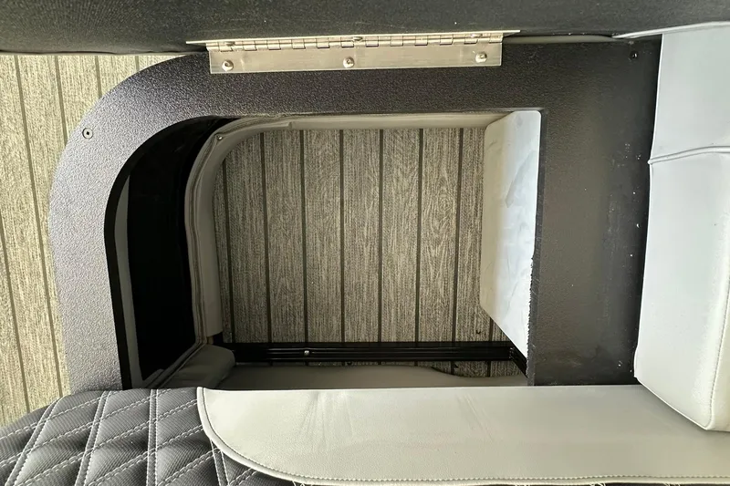 Slide: The Image of Interior view of 2026 Ranger Reata 223FC boat with seating and storage compartment. - 31