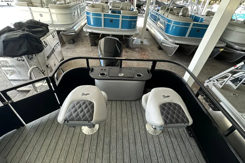Slide: The Image of 2026 Ranger Reata 223FC boat interior with two cushioned seats and storage compartment. - 32