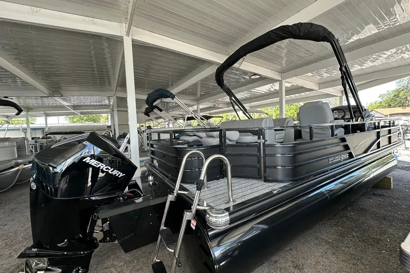 Slide: The Image of 2026 Ranger Reata 223FC pontoon boat with Mercury engine in covered storage. - 35