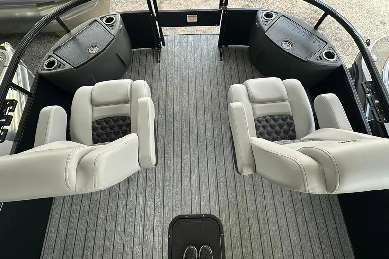 Slide: The Image of 2026 Ranger Reata 223FC boat interior with gray seating and flooring. - 7