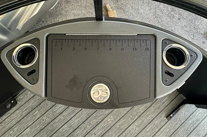 Slide: The Image of 2026 Ranger Reata 223FC boat console with cup holders and measuring board. - 9