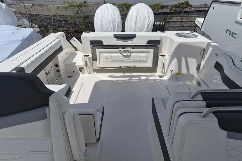 Slide: The Image of 2026 Robalo R277 Dual Console boat interior with seating and storage features. - 12