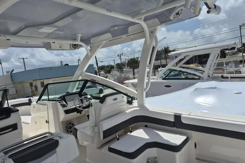 Slide: The Image of 2026 Robalo R277 Dual Console boat interior with modern seating and steering console. - 13