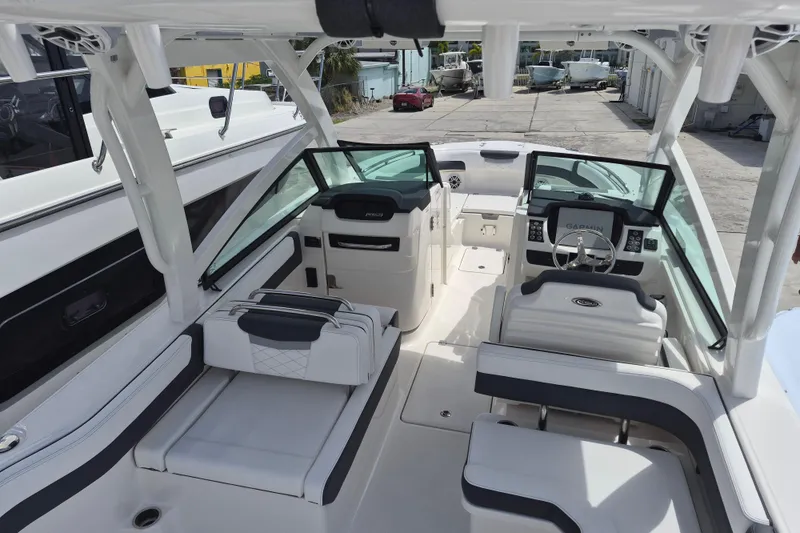 Slide: The Image of 2026 Robalo R277 Dual Console boat interior with modern seating and navigation system. - 16