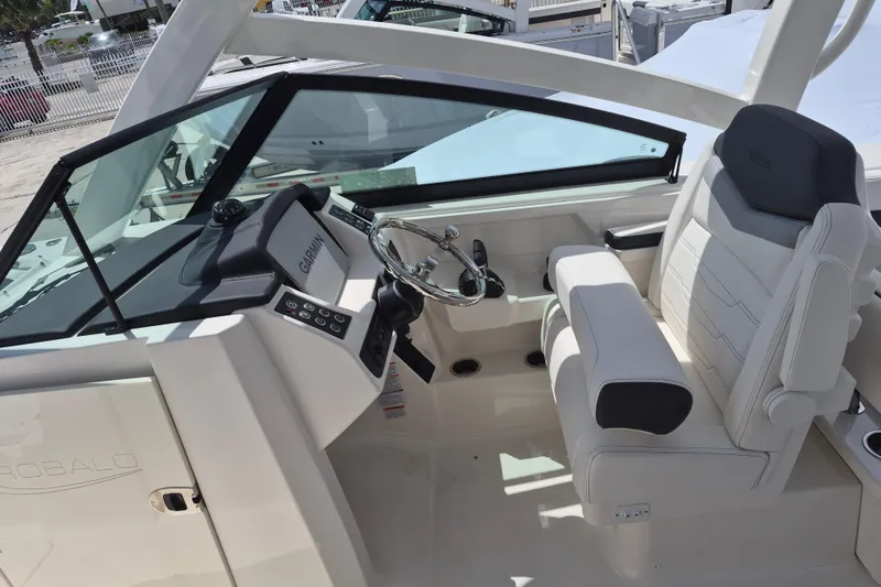 Slide: The Image of 2026 Robalo R277 Dual Console boat interior with modern helm and comfortable seating. - 4