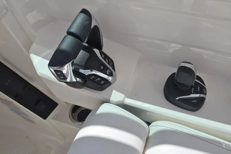 Slide: The Image of 2026 Robalo R277 Dual Console boat controls with joystick and throttle levers. - 8