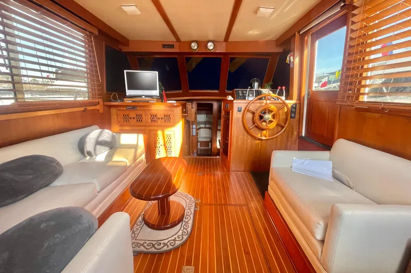 Slide: The Image of 1986 Tung Hwa aft cabin interior with wooden decor, steering wheel, and cozy seating area. - 10