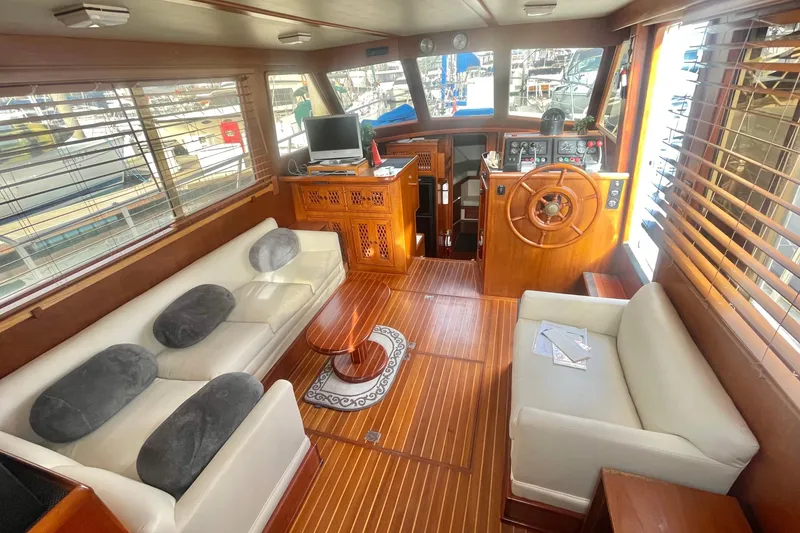 Slide: The Image of 1986 Tung Hwa aft cabin interior with wooden helm, sofas, and nautical decor. - 12