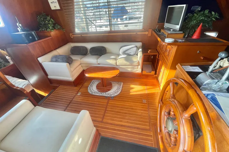 Slide: The Image of 1986 Tung Hwa aft cabin interior with wooden flooring, cozy seating, and nautical decor. - 19