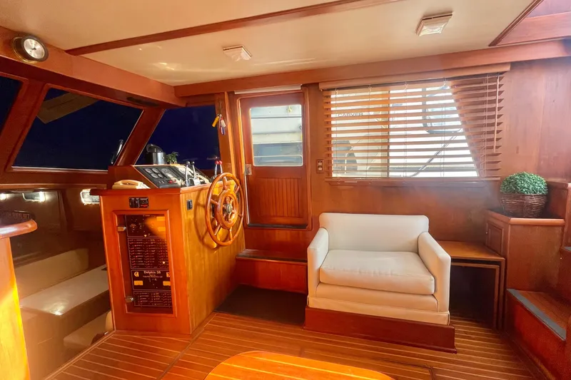 Slide: The Image of 1986 Tung Hwa aft cabin interior with wooden helm, white armchair, and blinds. - 20