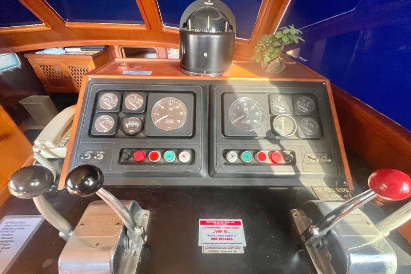 Slide: The Image of 1986 Tung Hwa aft cabin boat dashboard with gauges, controls, and a small plant. - 29