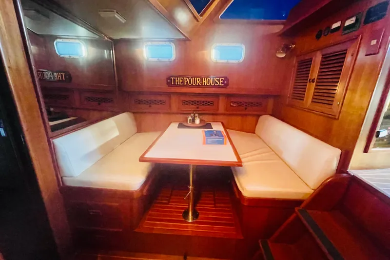Slide: The Image of 1986 Tung Hwa aft cabin interior with cozy dining area and wooden accents. - 30