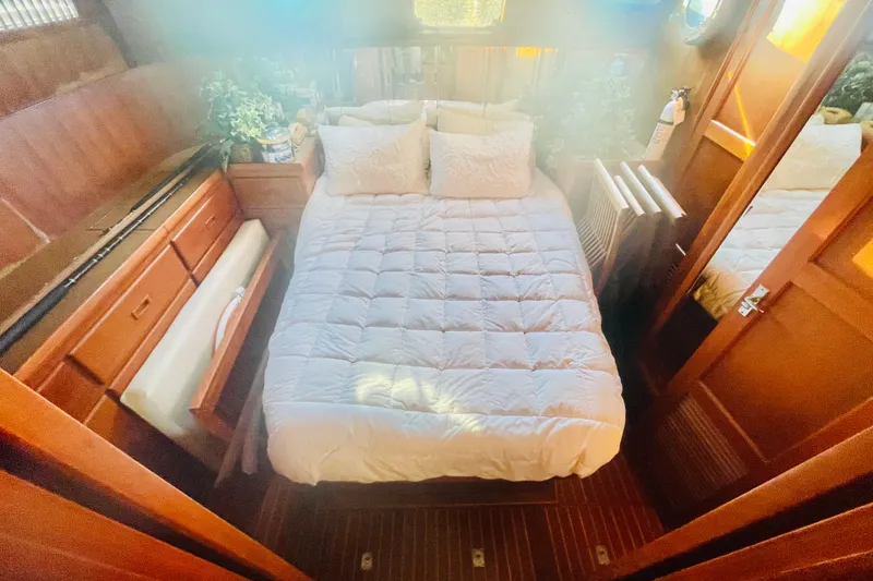 Slide: The Image of 1986 Tung Hwa aft cabin with cozy bed, wooden interior, and decorative plants. - 34
