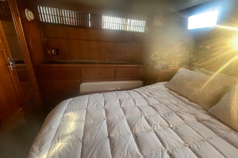 Slide: The Image of 1986 Tung Hwa aft cabin interior with cozy bed and wooden furnishings. - 36