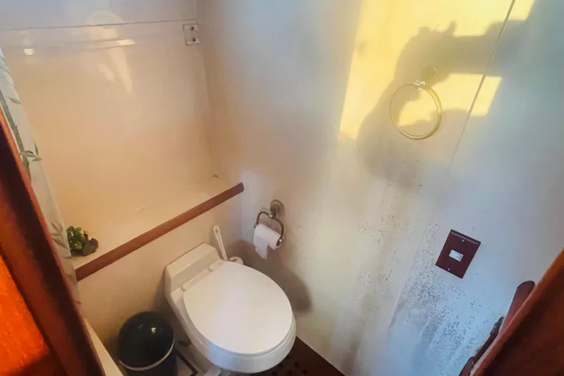 Slide: The Image of 1986 Tung Hwa aft cabin bathroom with toilet, towel ring, and natural lighting. - 37