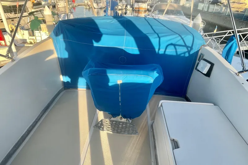 Slide: The Image of 1986 Tung Hwa aft cabin boat with blue covers, docked at marina. - 4