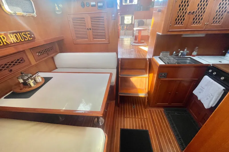 Slide: The Image of 1986 Tung Hwa aft cabin interior with dining area, kitchen, and wooden flooring. - 41