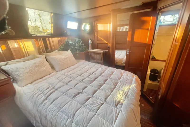Slide: The Image of 1986 Tung Hwa aft cabin with cozy bed, wooden interior, and natural light. - 43