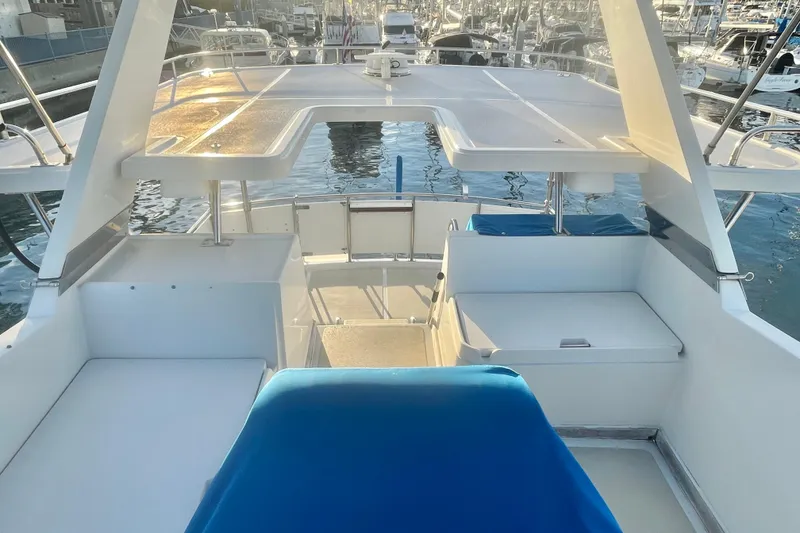 Slide: The Image of 1986 Tung Hwa aft cabin yacht interior with blue seating, docked at marina. - 6