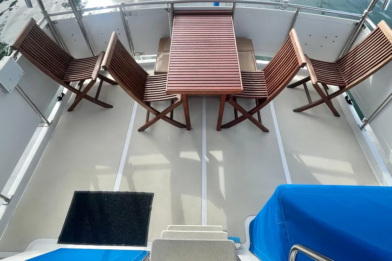 Slide: The Image of 1986 Tung Hwa aft cabin with wooden chairs and table on deck. - 7