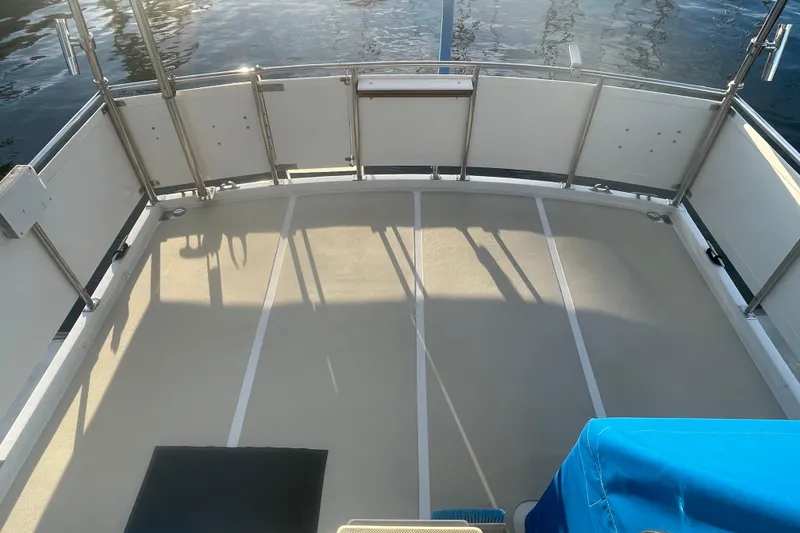 Slide: The Image of 1986 Tung Hwa aft cabin boat deck with railing, overlooking calm water. - 9