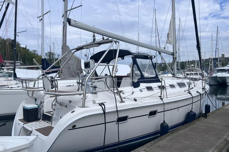 The Image of 2006 Hunter 38 sailboat docked at marina with clear sky background. - 0