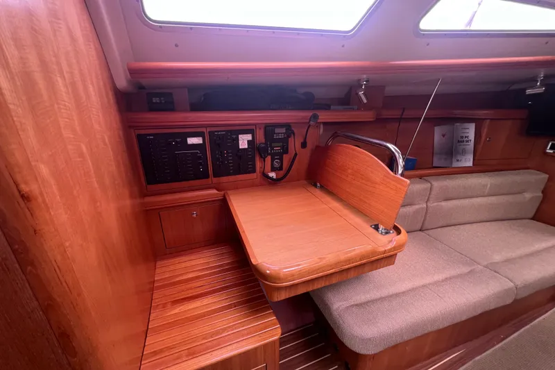 Slide: The Image of Interior of 2006 Hunter 38 sailboat with navigation station and seating area. - 12