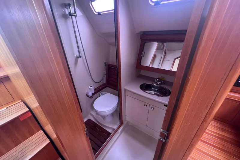 Slide: The Image of Interior of 2006 Hunter 38 yacht bathroom with shower, toilet, and sink. - 15