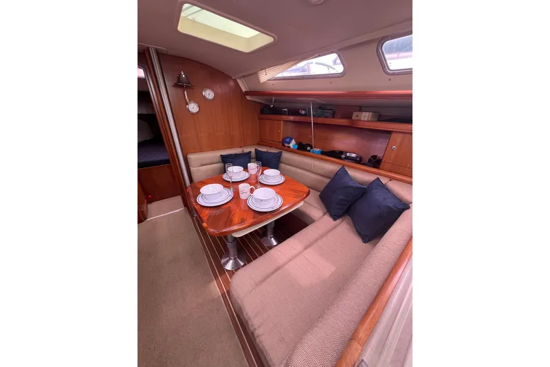 Slide: The Image of Cozy interior of 2006 Hunter 38 sailboat with dining area and tableware. - 18
