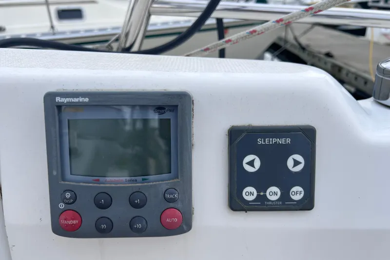 Slide: The Image of Control panel on a 2006 Hunter 38 sailboat featuring Raymarine and Sleipner systems. - 3