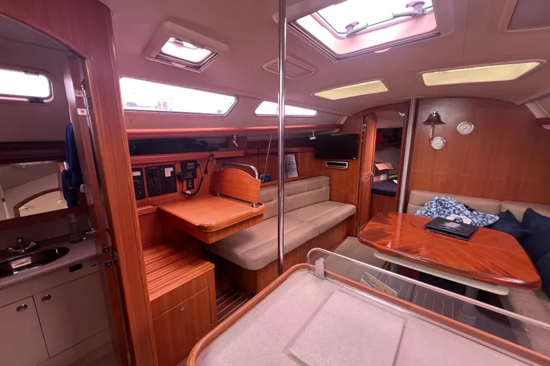 Slide: The Image of Interior of a 2006 Hunter 38 sailboat with wood finishes and seating area. - 8