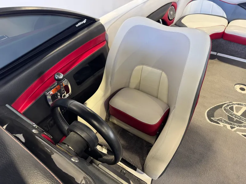 Slide: The Image of Interior of a 2012 Malibu Wakesetter 23 LSV boat with steering wheel and seat. - 21