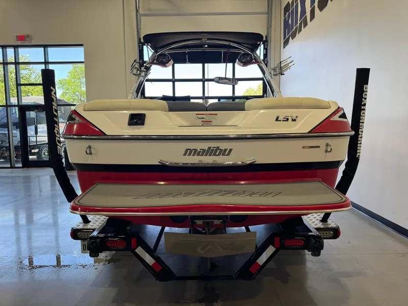 Slide: The Image of Rear view of a 2012 Malibu Wakesetter 23 LSV boat in a showroom. - 6