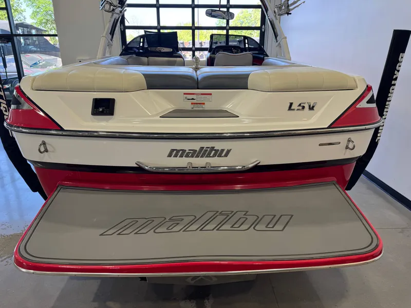 Slide: The Image of Rear view of a 2012 Malibu Wakesetter 23 LSV boat in showroom. - 8